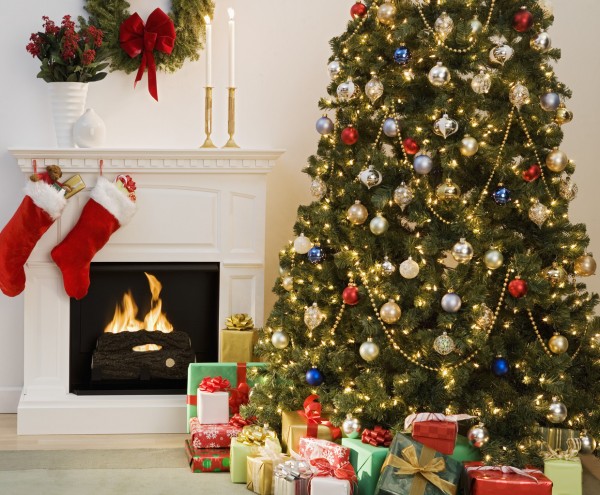 Christmas tree with presents and fireplace with stockings — Image by © Royalty-Free/Corbis