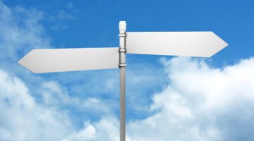 Signpost in blue sky with clouds